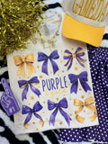 Purple and gold bows T-shirt by P&PD Wholesale featuring a playful bow design on natural-colored fabric.