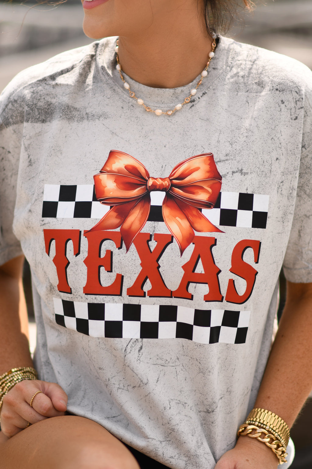 Grey Texas checkered bow tee by P&PD Wholesale, featuring a casual short-sleeve design with a bow detail at the neckline.