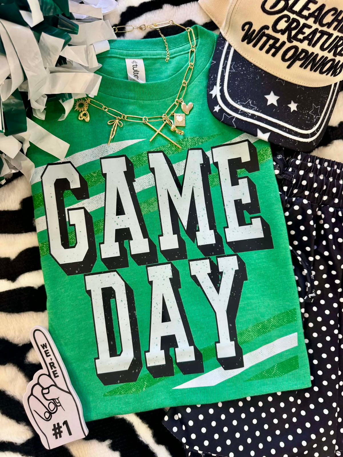 Heather Kelly green P&PD Wholesale Game Day Stripes Tee showing the green and white striped design on a casual t-shirt.