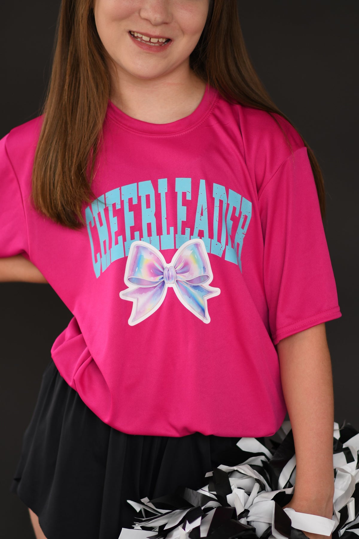 Hot pink cheerleader bow dri-fit tee for women, featuring a vibrant cheerleader design and comfortable athletic fit.