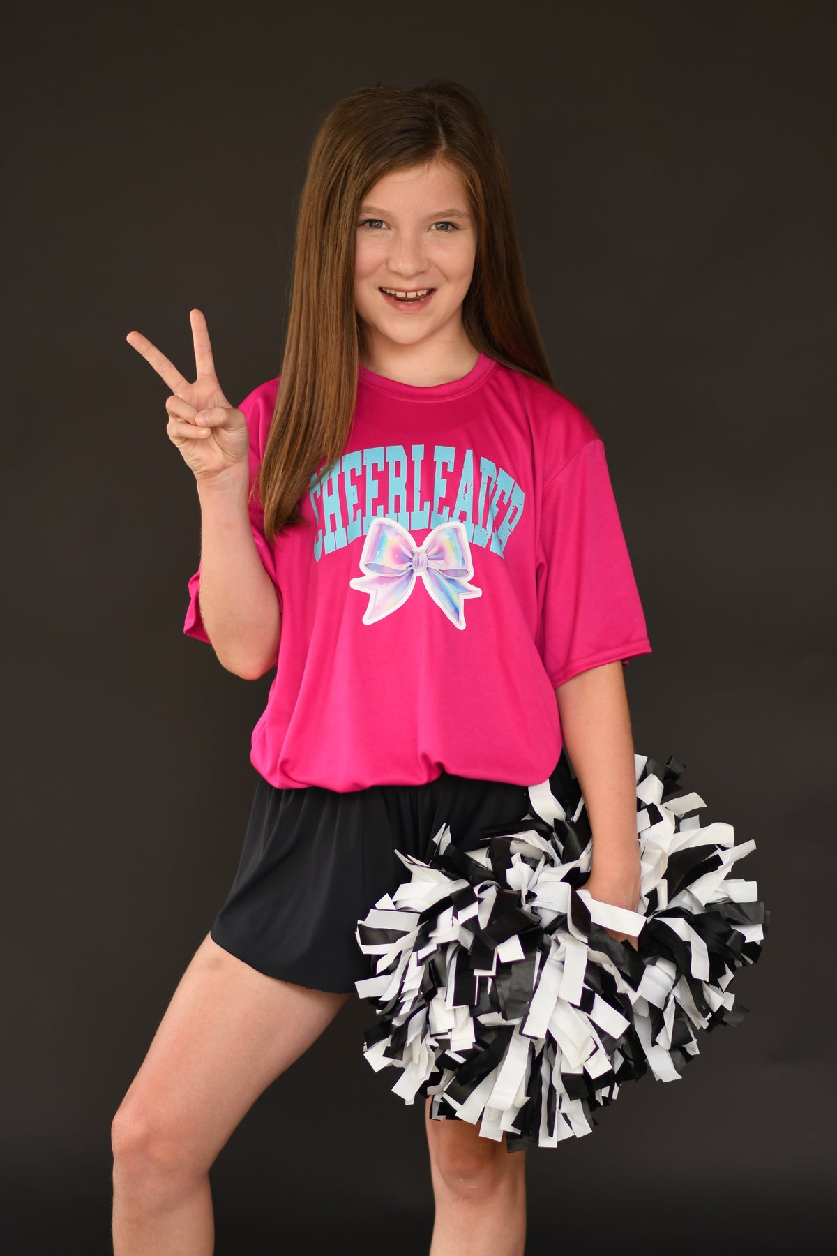 Hot pink Dri-Fit cheerleader bow tee by P&PD Wholesale, featuring a cheerleader bow design on a fitted athletic shirt.