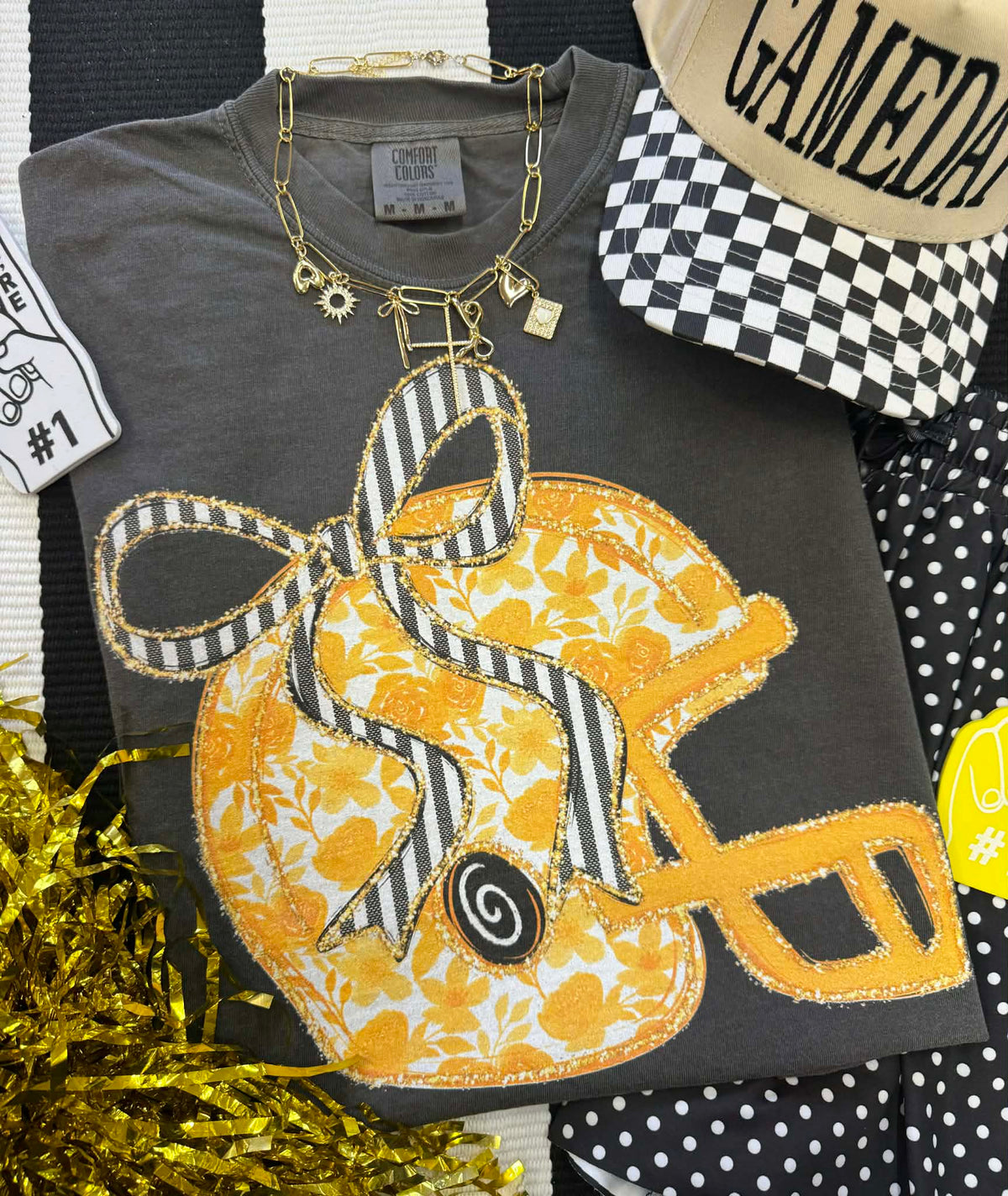 Gold floral helmet tee by P&PD Wholesale, featuring a vibrant floral design on a casual gold-colored T-shirt.