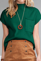 Shewin oatmeal patch pocket ribbed knit short sleeve sweater, close-up of beige knit fabric with patch pocket detail.