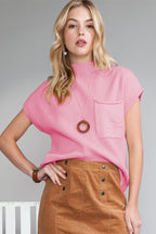 Shewin oatmeal patch pocket ribbed knit short sleeve sweater, close-up of beige knit fabric with front patch pocket detail.