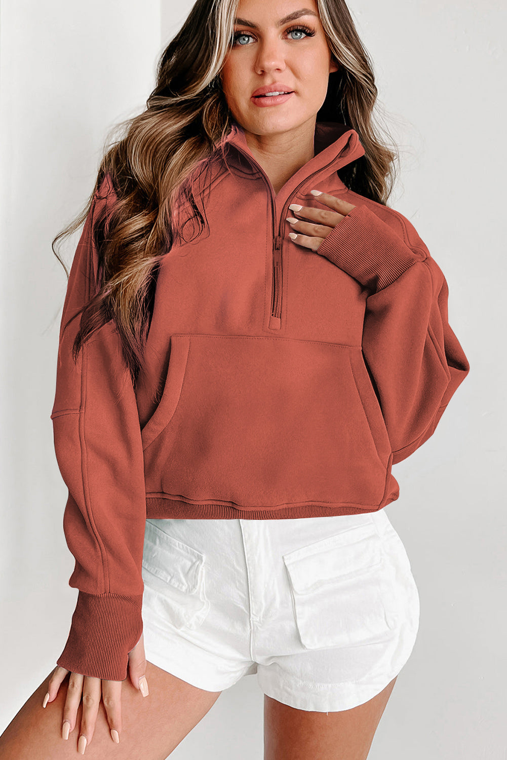 Brown zip-up sweatshirt with stand collar and thumbhole sleeves by Shewin, casual and comfortable for everyday wear.