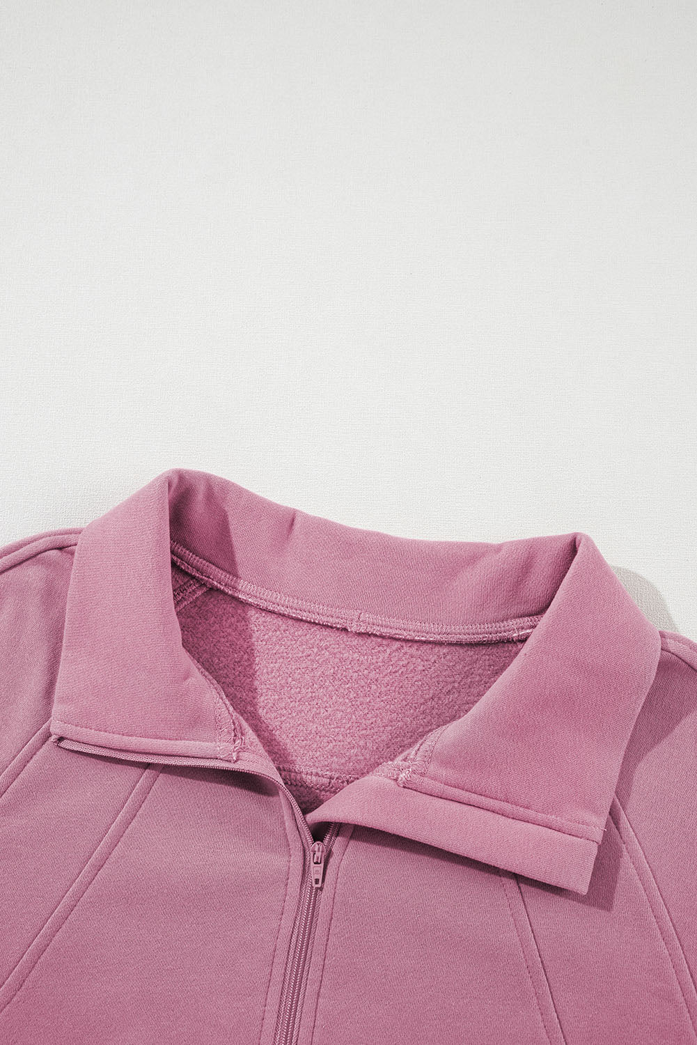 Brown zip-up sweatshirt with stand collar and thumbhole sleeves by Shewin, featuring a cozy, casual design.