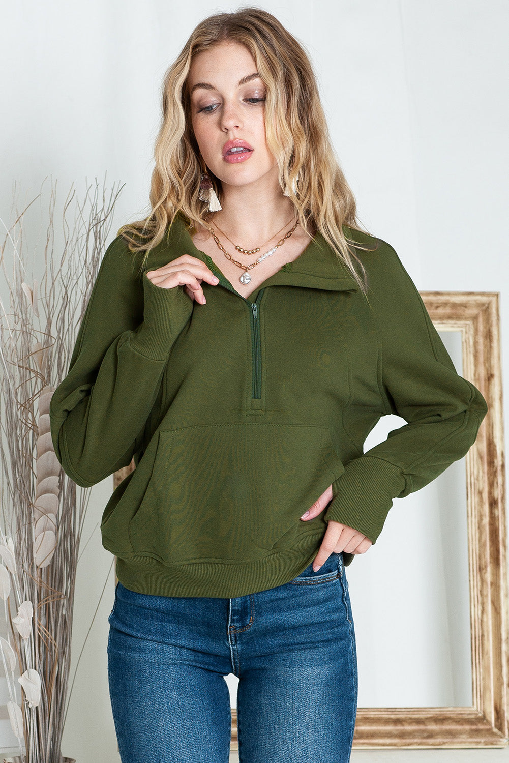 Brown zip-up sweatshirt with stand collar and thumbhole sleeves by Shewin, shown with a casual fit and cozy design.