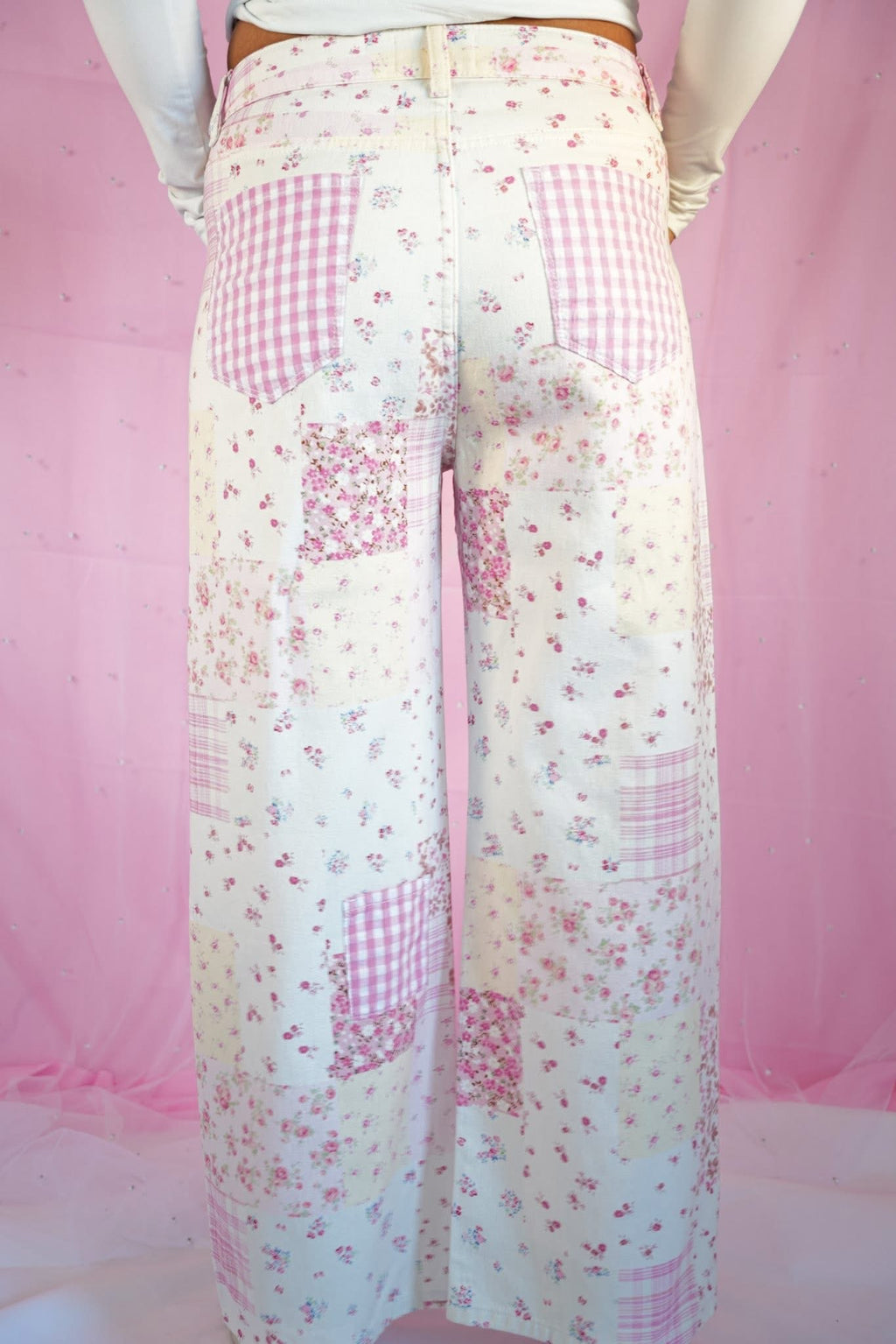Starstruckd pink floral and gingham patchwork jeans with colorful floral and checkered fabric details.
