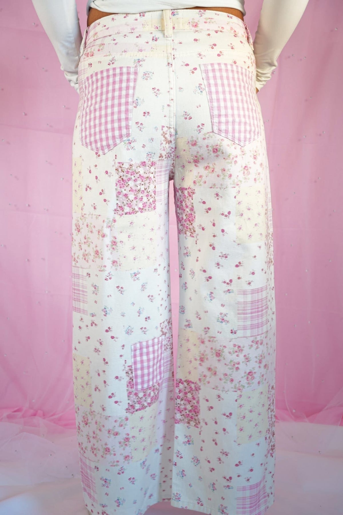 Starstruckd pink floral and gingham patchwork jeans with colorful floral and checkered fabric details.