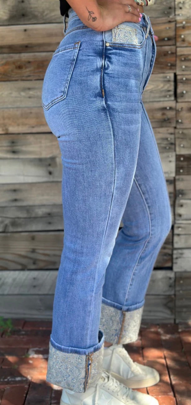 Sterling Kreek embroidered cuffed jeans featuring detailed embroidery and a relaxed fit, denim fabric, and cuffed hems.