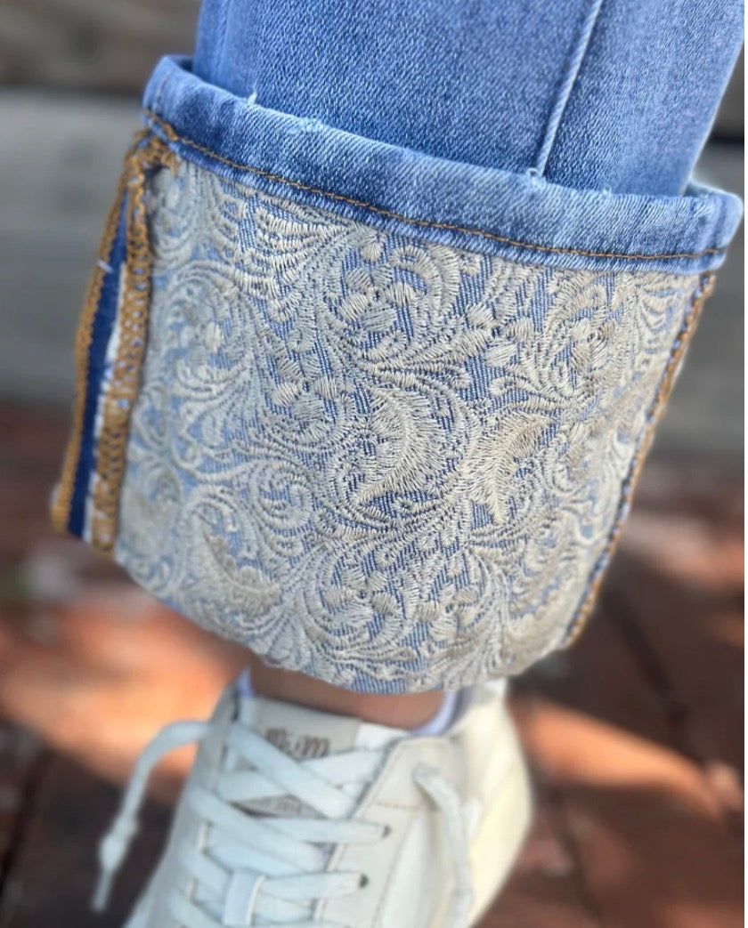 Sterling Kreek embroidered cuffed jeans featuring intricate embroidery and a relaxed fit, displayed on a model.