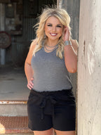 Black Brenna tie-waist shorts by Texas True Threads, stylish bottoms with a flattering fit and adjustable waist detail.