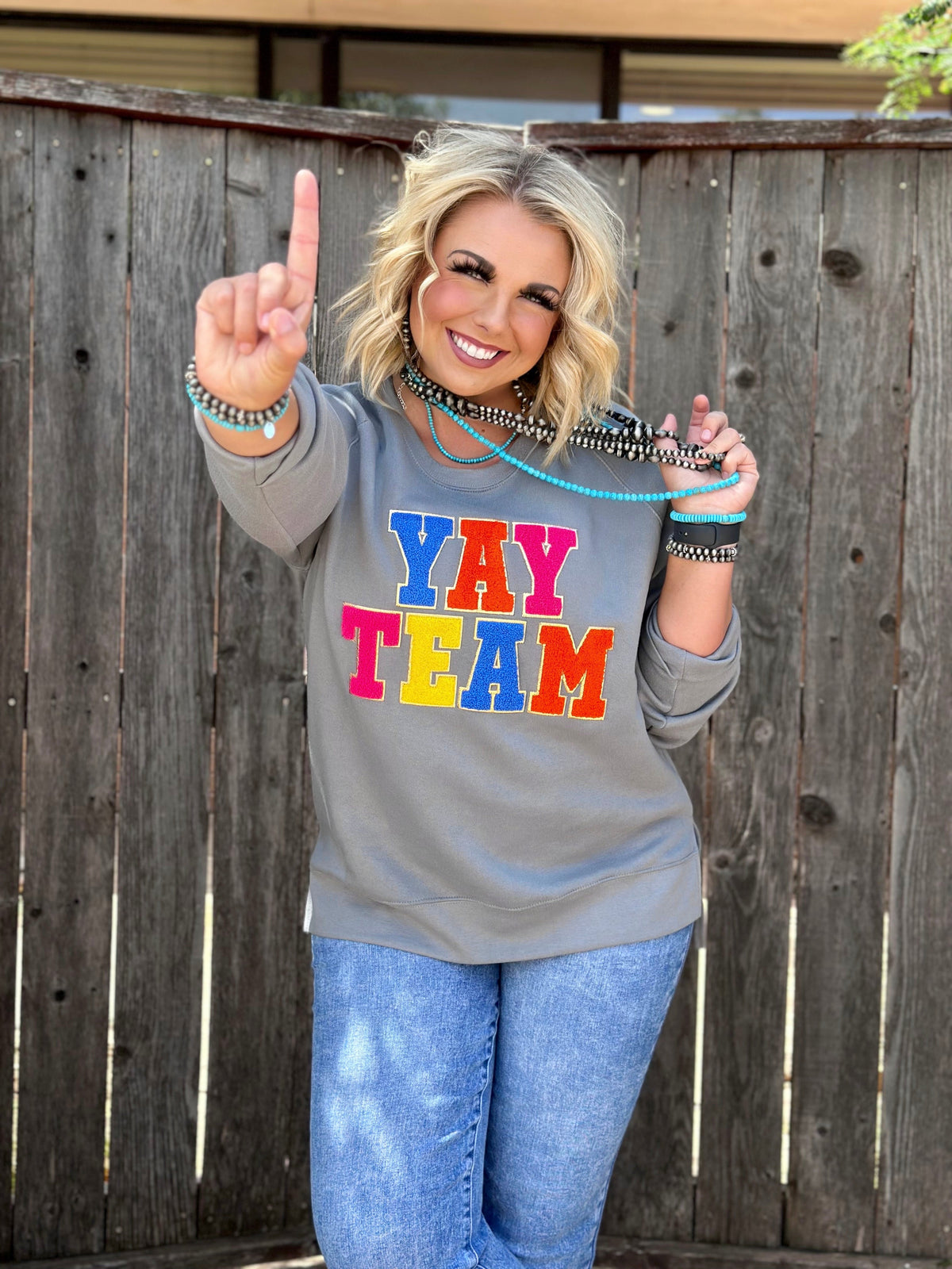 Gray Sync Logic Yay Team chenille applique sweatshirt by Texas True Threads, showing the front design and cozy fabric.