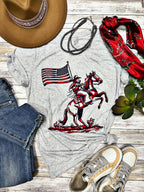 White Patriotic Cowboy Tee by Texas True Threads featuring a patriotic cowboy graphic on the front.