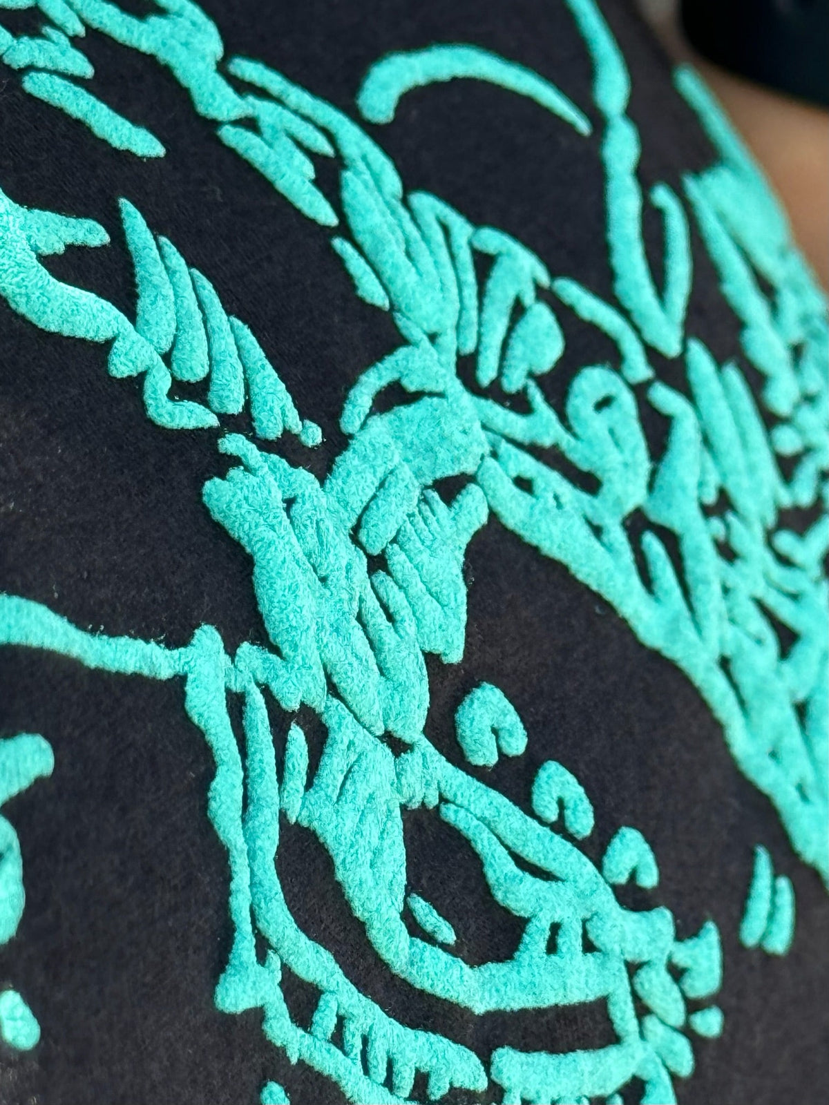 Black Texas True Threads Roughrider in Turquoise Puff Tee, crew neck t-shirt with graphic design, casual style.