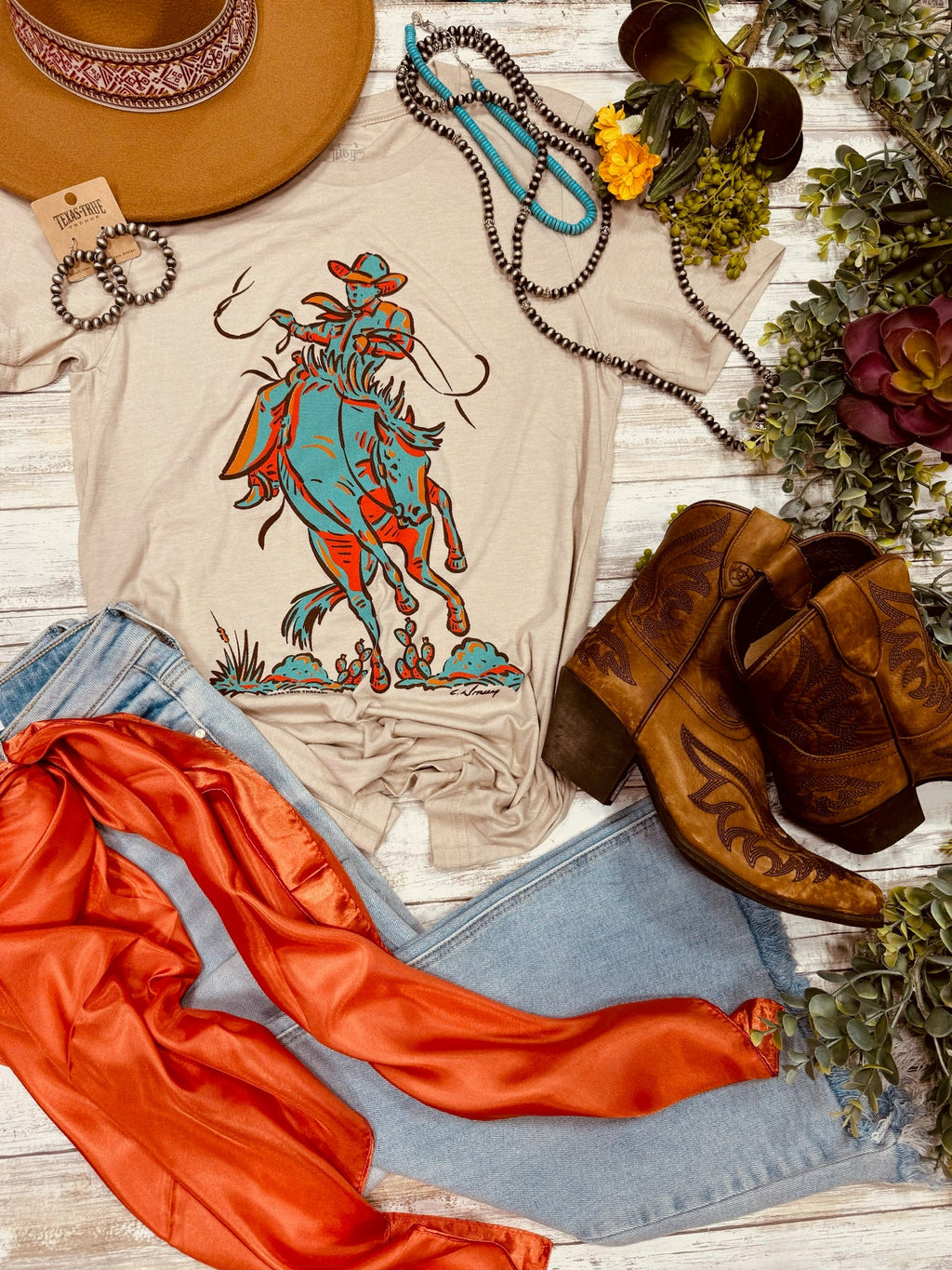 Heather tan Sunset Cowboy T-shirt by Texas True Threads featuring a cowboy silhouette and sunset graphic.
