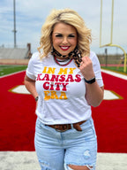 White crew neck T-shirt from Texas True Threads featuring "In My Kansas City Era" by Randi Mahomes, casual and stylish.