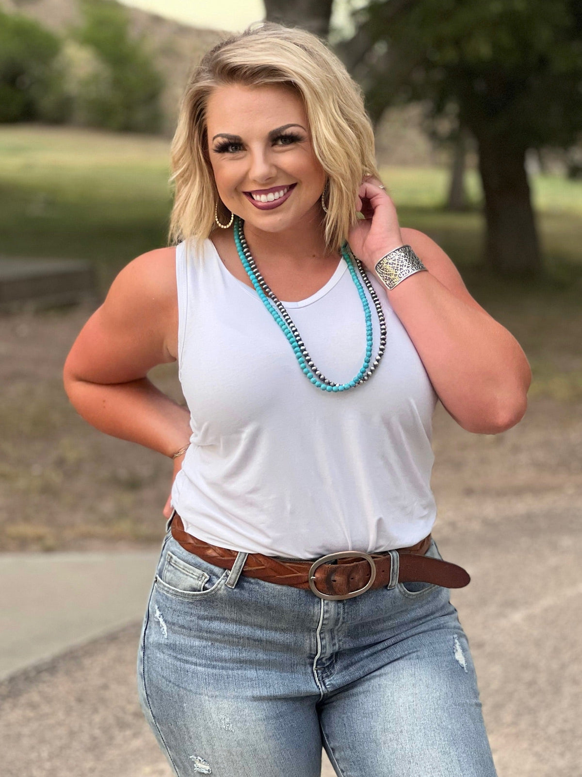 White Jules V-neck sleeveless top by Texas True Threads, casual sleeveless blouse with a V-neck design.