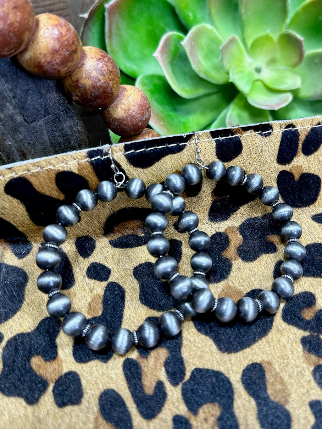 Wylie Earrings by Texas True Trends, stylish drop earrings with intricate design, gold-tone finish, and dangling elements.