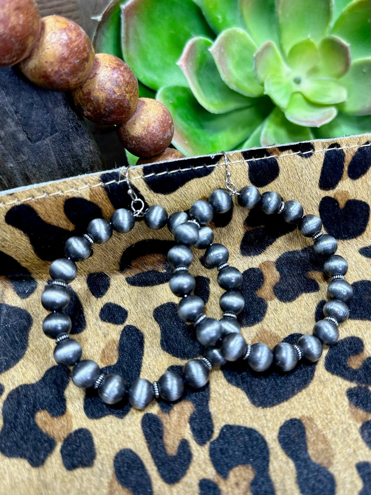 Wylie Earrings by Texas True Trends, stylish drop earrings with intricate design, gold-tone finish, and dangling elements.