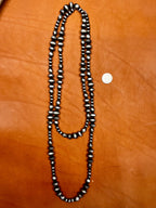 Texas True Trends Amarillo Long Necklace featuring a stylish, elongated design with intricate beadwork and vibrant yellow accents.