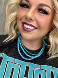 Turquoise Spearman necklace by Texas True Trends featuring a beaded design and silver accents, displayed on a neutral background.