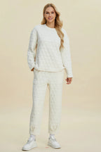 Beige Trendsi double take full size textured round neck long sleeve top and matching pants set displayed on a model.