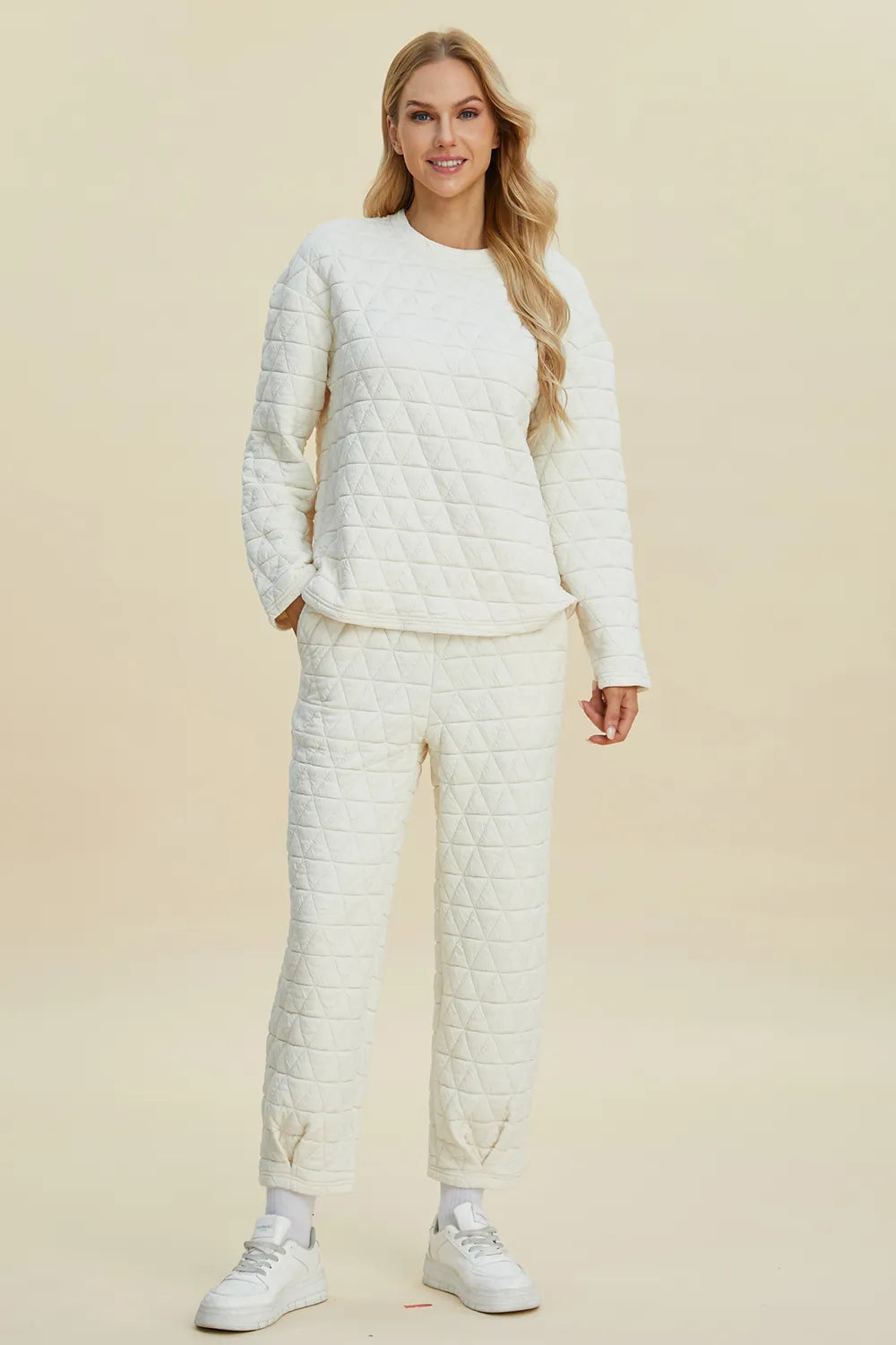 Beige Trendsi double take full size textured round neck long sleeve top and matching pants set displayed on a model.
