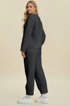 Beige textured pants from Trendsi's Double Take full-size set, featuring a round neck long sleeve top and matching pants.
