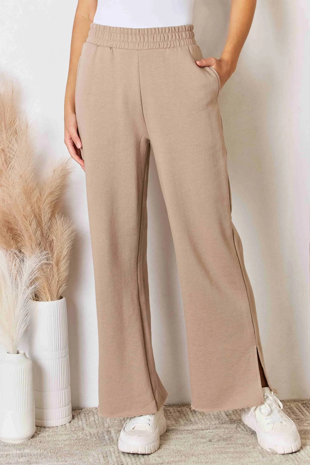 Tan RISEN wide waistband slit wide-leg pants from Trendsi, featuring a relaxed fit and stylish slit detail.