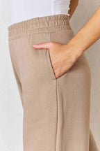 Tan RISEN wide waistband slit wide-leg pants with flowing fabric and relaxed fit, perfect for casual and stylish outfits.