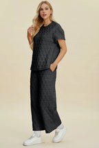 Black Trendsi double take two-piece set with textured round neck short sleeve top and matching pants, casual and comfortable.