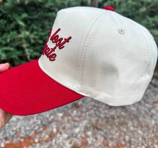 Crimson Wicker Road Never Lost A Tailgate hat with adjustable strap, stylish and comfortable for outdoor tailgating events.
