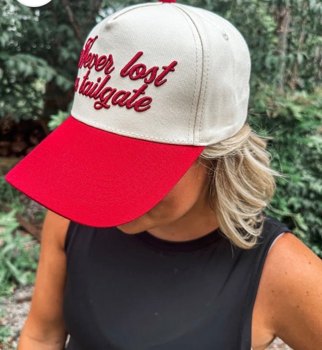 Crimson "Never Lost A Tailgate" hat by Wicker Road featuring embroidered text and casual baseball cap style.