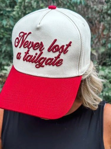 Crimson "Never Lost A Tailgate" hat by Wicker Road, adjustable baseball cap with embroidered text and casual style.